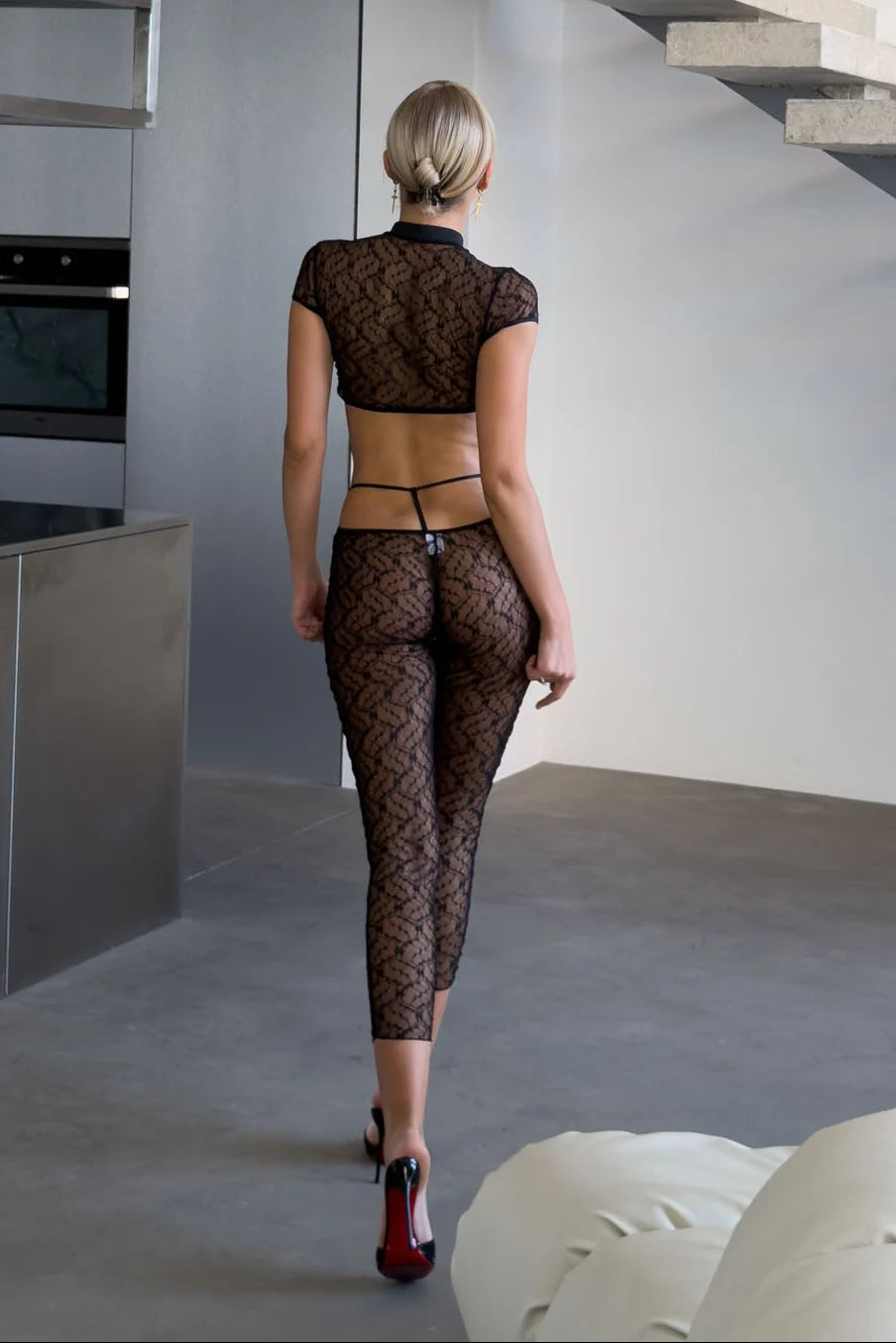 Celeste Noir black sheer floral lace two-piece lingerie set featuring a high-neck cutout crop top, short sleeves, decorative front closures and matching high-waisted lace leggings.