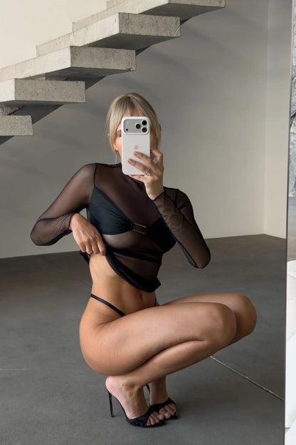 Elara Midnight black sheer mesh lingerie set featuring a long-sleeve high-neck top, bandeau-style bust with gold-tone center accent, and matching strappy thong.